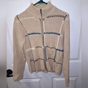 A Woolrich chunky cable knit full zip ladies sweater in a size medium.